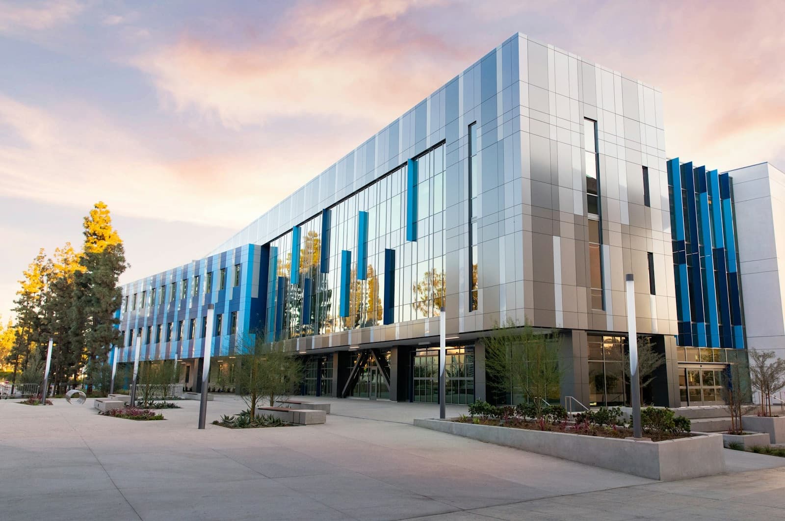 A modern school campus building at dusk, the kind of institution Scholr builds for