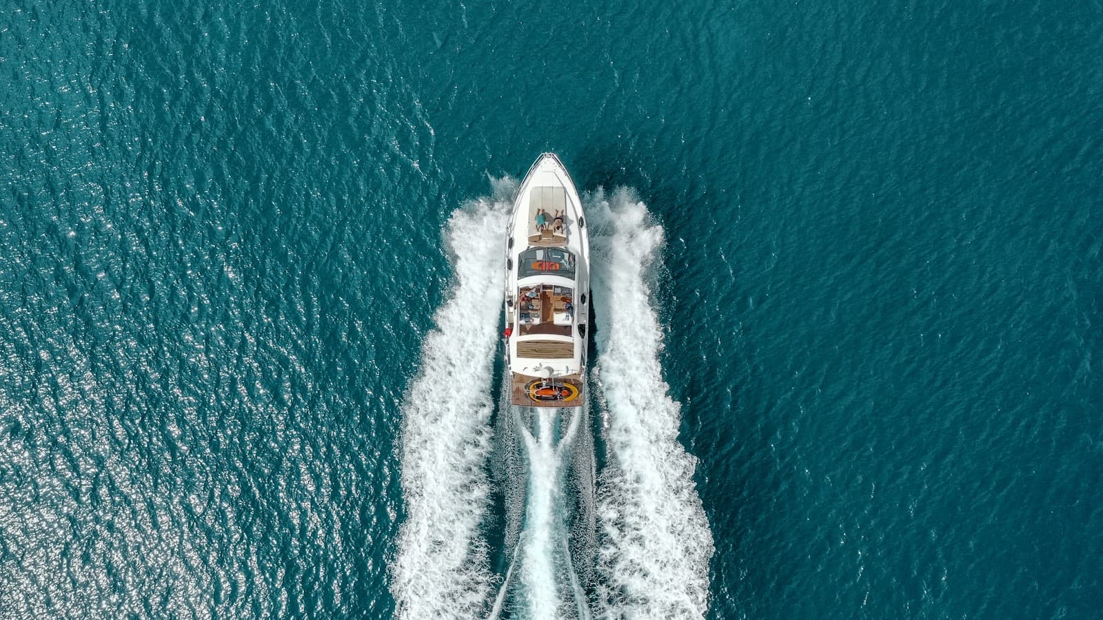 A charter yacht under way on open water, the setting for Yacht Rave